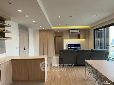 Modern open-plan living room with sleek furniture and city view