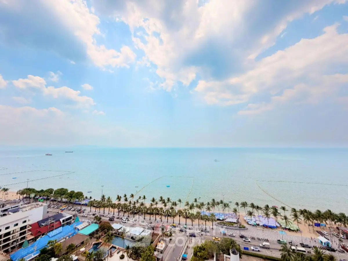 Stunning ocean view from high-rise building, showcasing expansive coastline and vibrant cityscape.