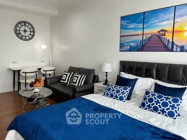 Modern studio apartment with stylish decor and cozy living area.