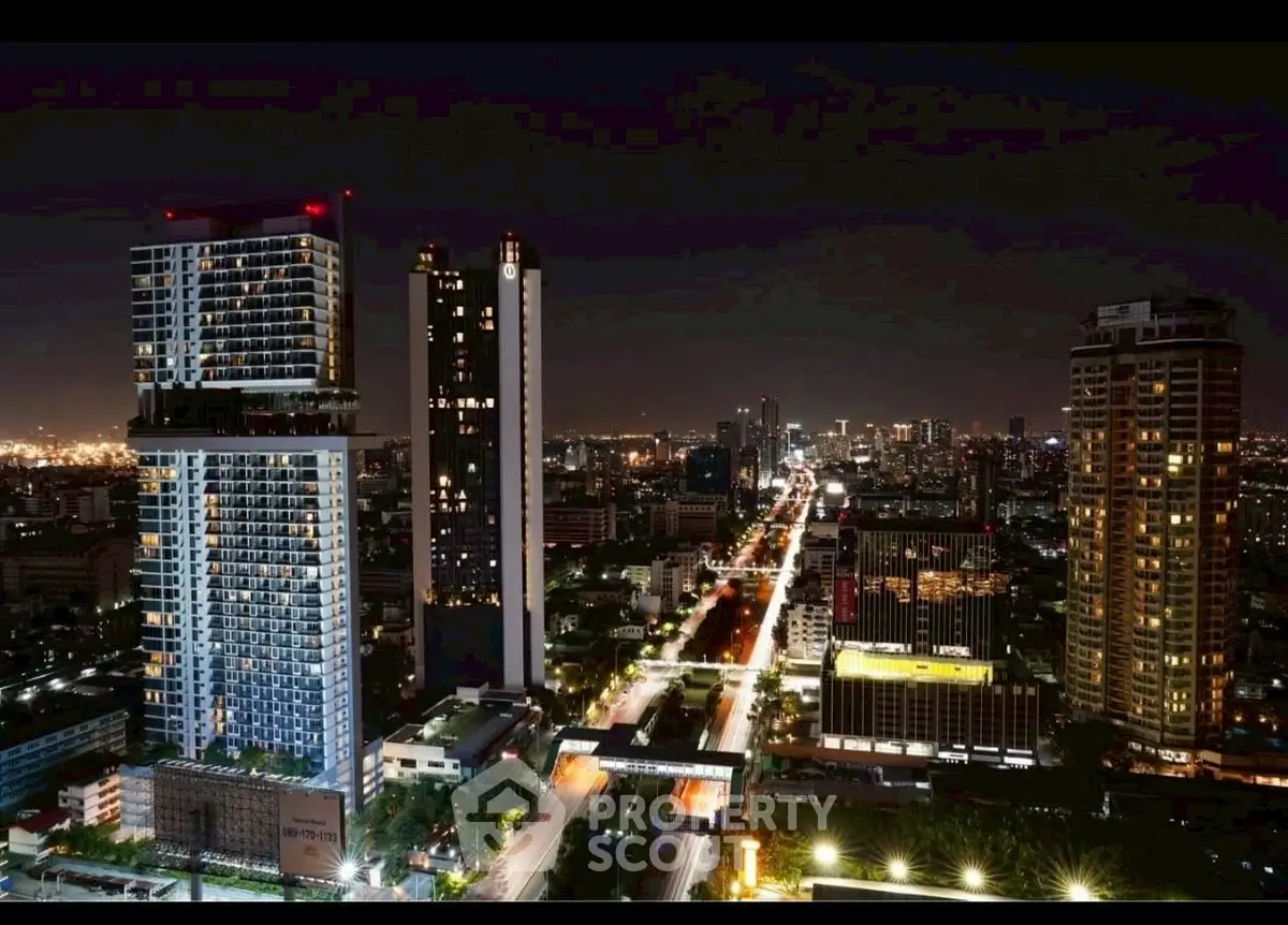 Stunning night view of city skyline with illuminated high-rise buildings and bustling streets.