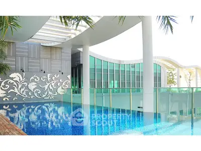 Luxurious rooftop pool with modern architectural design and glass railings, perfect for relaxation and leisure.