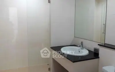 Modern bathroom with sleek sink and large mirror in a contemporary home.