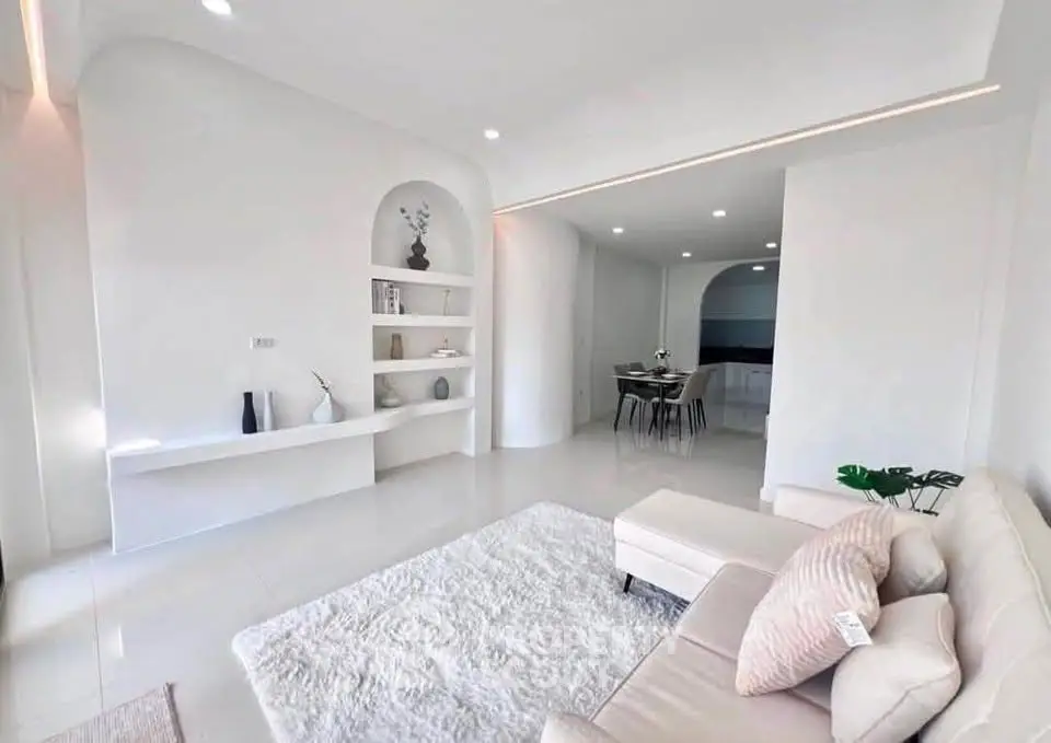 Elegant modern living room with white decor and cozy seating area