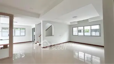 Spacious and bright living room with modern design and large windows.