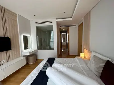 Luxurious modern bedroom with elegant decor and spacious layout, featuring a stylish bed and ambient lighting.