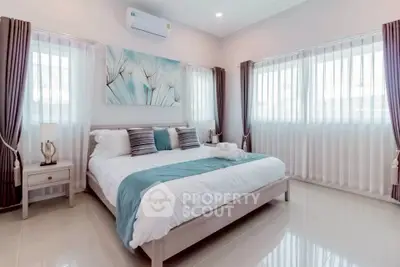 Spacious and bright bedroom with modern decor and large windows