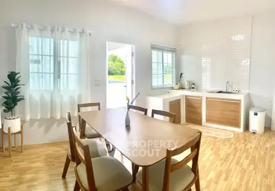 Bright and airy kitchen with wooden dining set and modern appliances