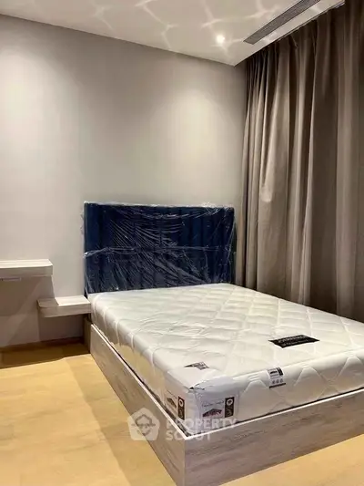 Modern bedroom with new mattress and stylish headboard, perfect for a cozy living space.