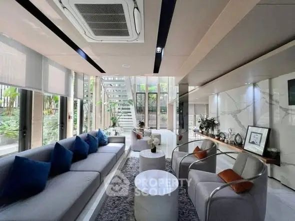 Luxurious modern living room with elegant decor and large windows