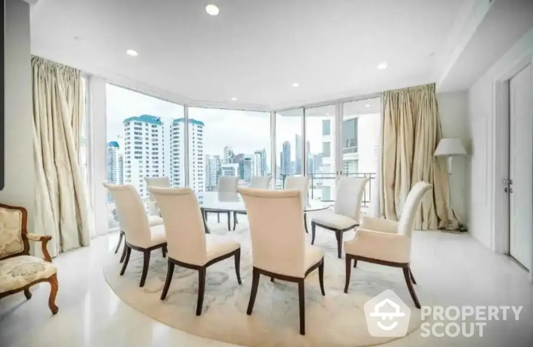 Expansive and elegantly furnished living room with panoramic city views through floor-to-ceiling windows, featuring a sophisticated dining area.