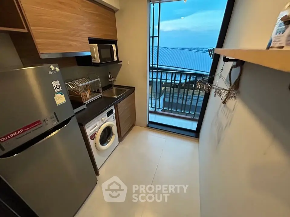 Modern kitchen with appliances and balcony view in a stylish apartment