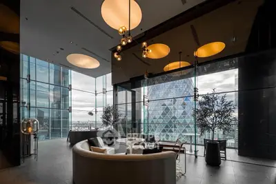 Luxurious modern living room with panoramic city view and elegant lighting.