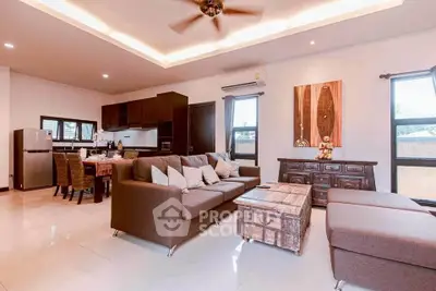 Spacious open-plan living room with modern kitchen and stylish decor