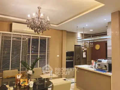 Luxurious kitchen with chandelier and modern appliances in elegant home