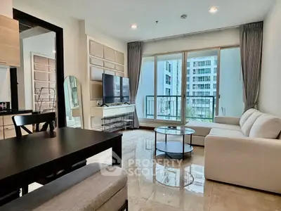 Modern living room with large windows and stylish furniture in a high-rise apartment.