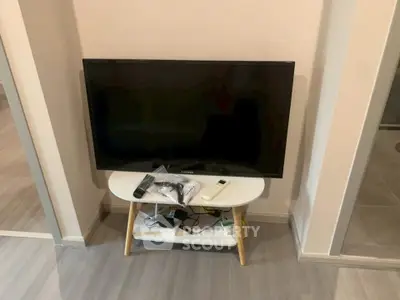 Modern living room with sleek TV setup on stylish stand, perfect for entertainment.