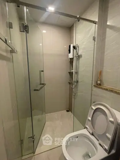 Modern bathroom with glass shower enclosure and sleek fixtures