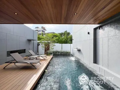 Luxurious modern pool area with sleek design and wooden deck