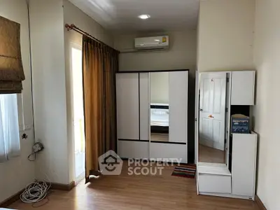 Spacious bedroom with modern wardrobe and balcony access