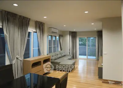 Spacious modern living room with elegant decor and large windows for natural light.