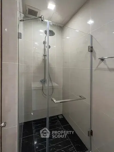 Modern shower with glass enclosure and sleek fixtures in a contemporary bathroom.