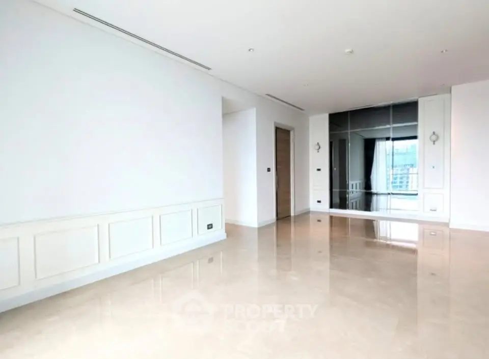 Spacious modern living room with glossy floors and large mirror wall