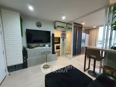Modern living room with open kitchen and stylish decor in a cozy apartment.