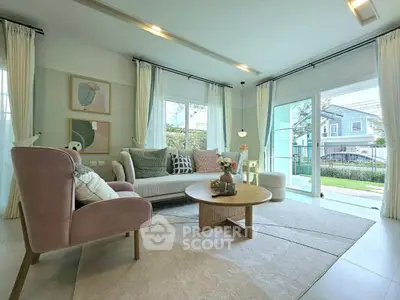 Elegant living room with modern decor and large windows overlooking garden