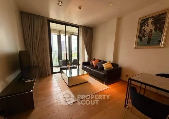 Modern living room with large windows and stylish decor in a high-rise apartment.