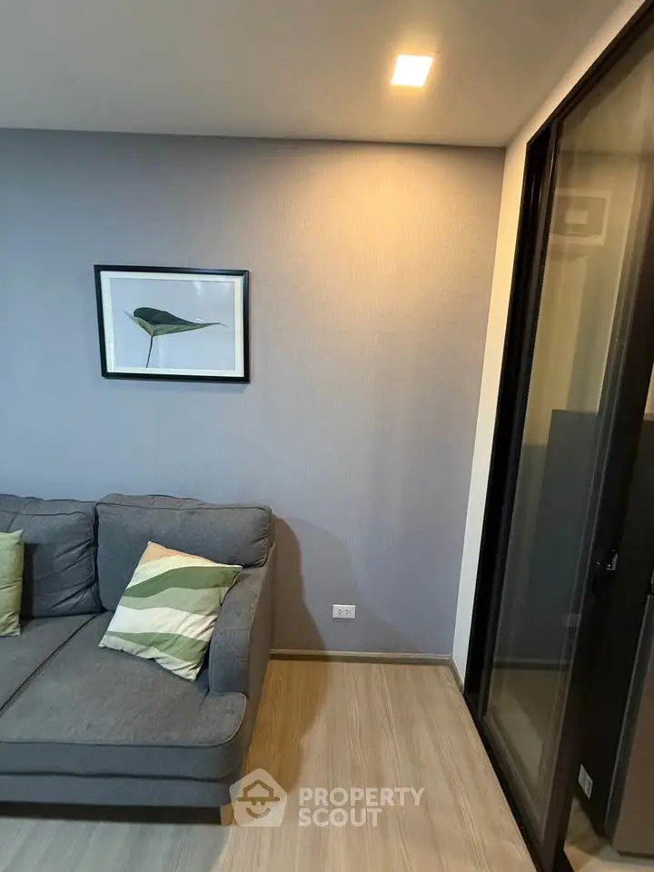 Modern living room with stylish gray sofa and elegant wall art