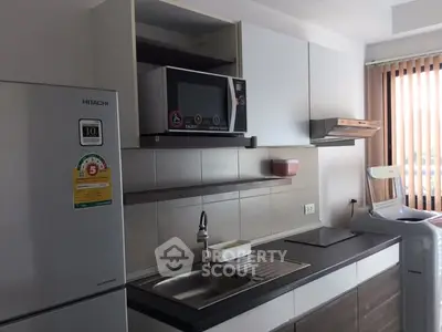Modern kitchen with sleek appliances and ample storage space