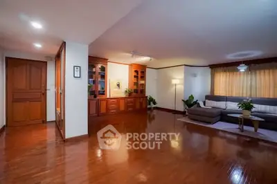 Spacious living room with wooden flooring and elegant decor in a modern home.