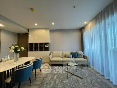 Modern living room with elegant decor and large windows in a stylish apartment.