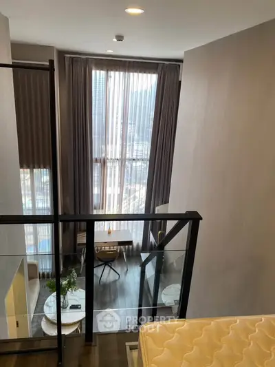 Stunning loft apartment with floor-to-ceiling windows and modern interior design.