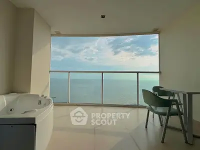 Luxurious balcony with ocean view and jacuzzi, perfect for relaxation.