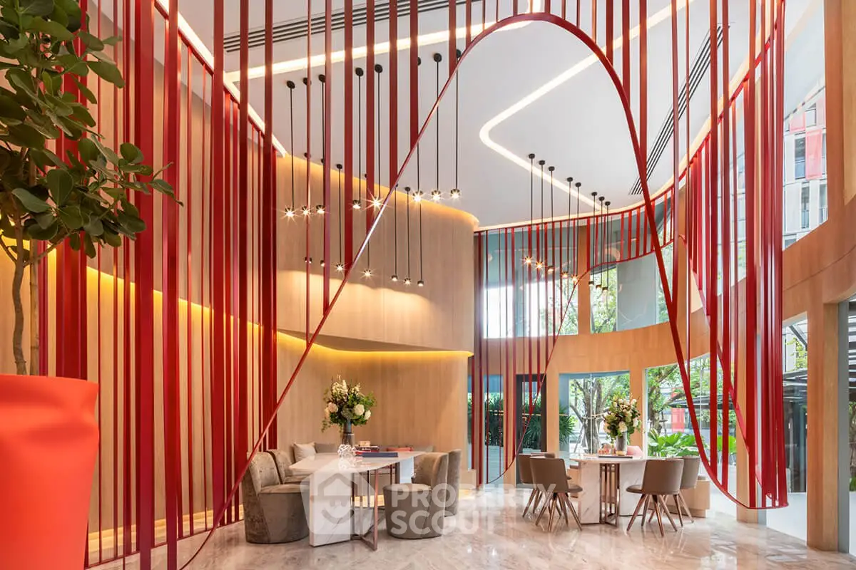 Luxurious modern living room with elegant decor and vibrant red accents