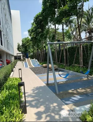 Lush green outdoor space with modern hammocks, perfect for relaxation in a serene residential environment, enhancing the living experience.