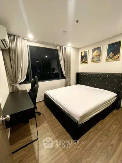 Modern bedroom with city view, stylish decor, and elegant furnishings