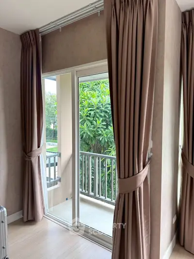 Spacious living room with large windows and abundant natural light.