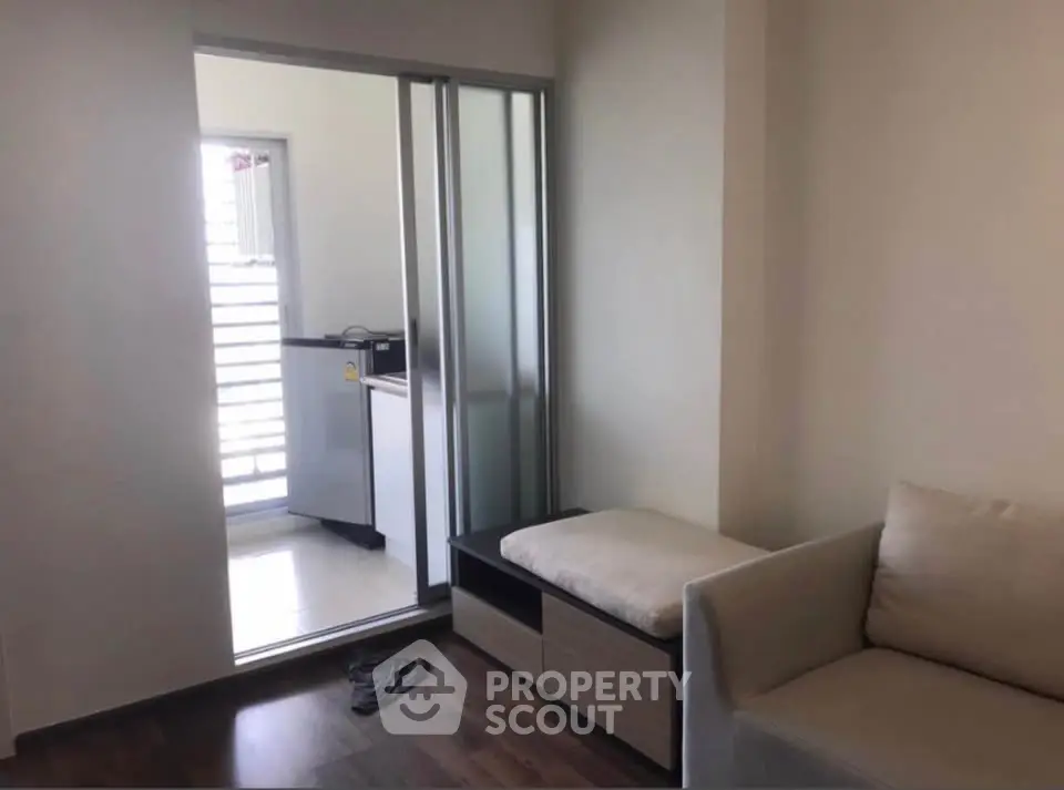 Modern apartment interior with sliding door and cozy seating area