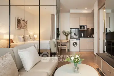 Modern studio apartment with cozy living area and compact kitchen