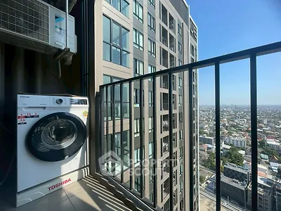 High-rise apartment balcony with washing machine and city view