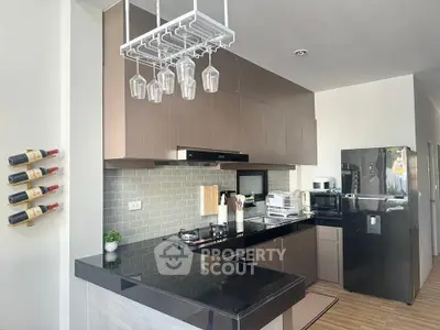 Modern kitchen with sleek black countertops and stylish wine rack