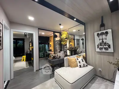 Modern living room with stylish decor and open layout, featuring cozy seating and contemporary artwork.