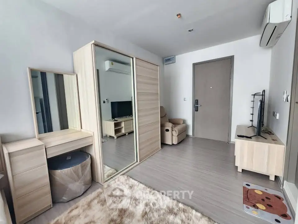 Modern living room with sleek furniture and cozy decor in a stylish apartment.