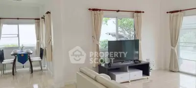 Bright living room with modern decor and large windows in a stylish home.