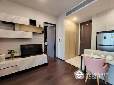 Modern apartment interior with integrated living space, featuring sleek kitchen appliances, a cozy dining area, and a stylish entertainment unit.