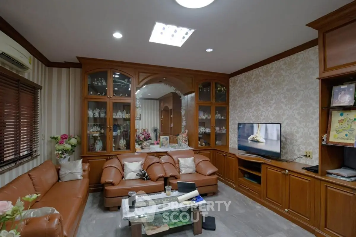 Elegant living room with leather sofas and built-in wooden cabinets