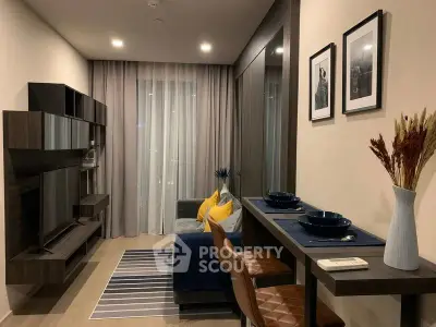 Modern living room with stylish decor and open layout, featuring a cozy sofa and elegant dining area.