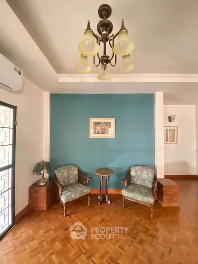 Charming living room with vintage chairs and elegant chandelier